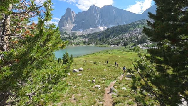 Looking down on a turquoise lake below the granite towers