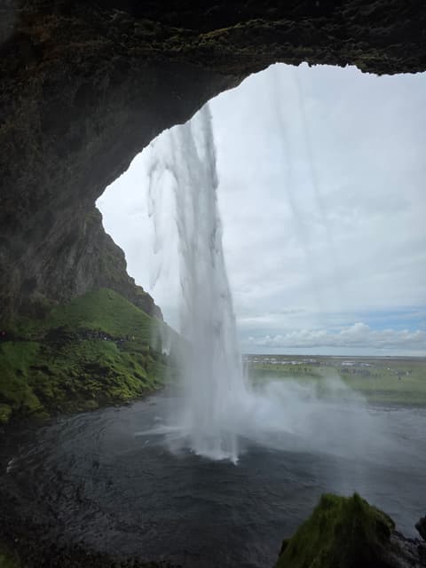 Looking out from behind the curtain of Seljalandsfoss waterfall