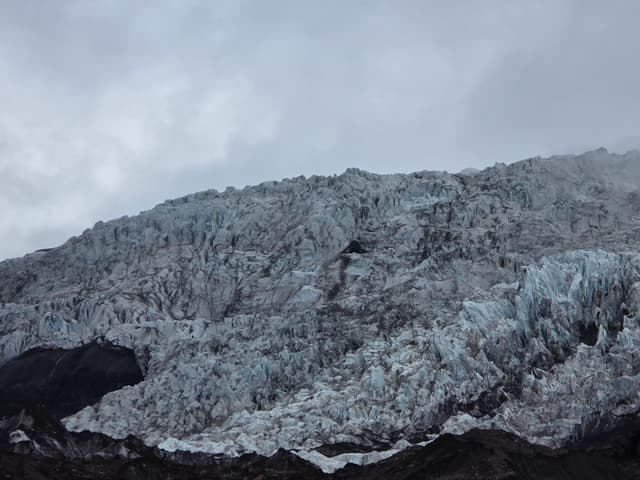 A crevassed blue-white glacier tongue