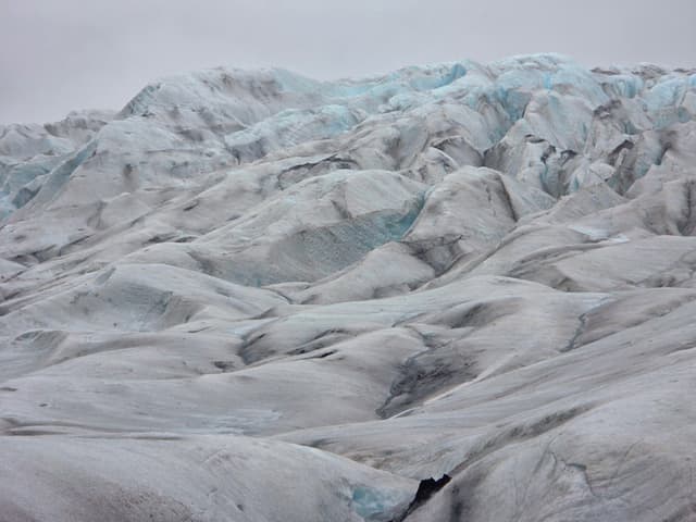 Rippled ice ridges and crevasses across a glacier