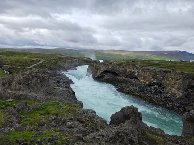 A turquoise river rushing through a lava gorge