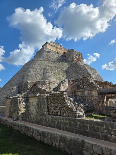 The rounded Pyramid of the Magician at Uxmal under a blue sky